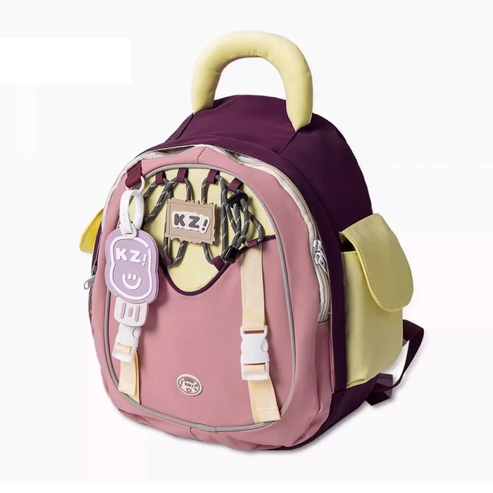 New College Style Backpack In Purple With Hanging Rubber Tag F